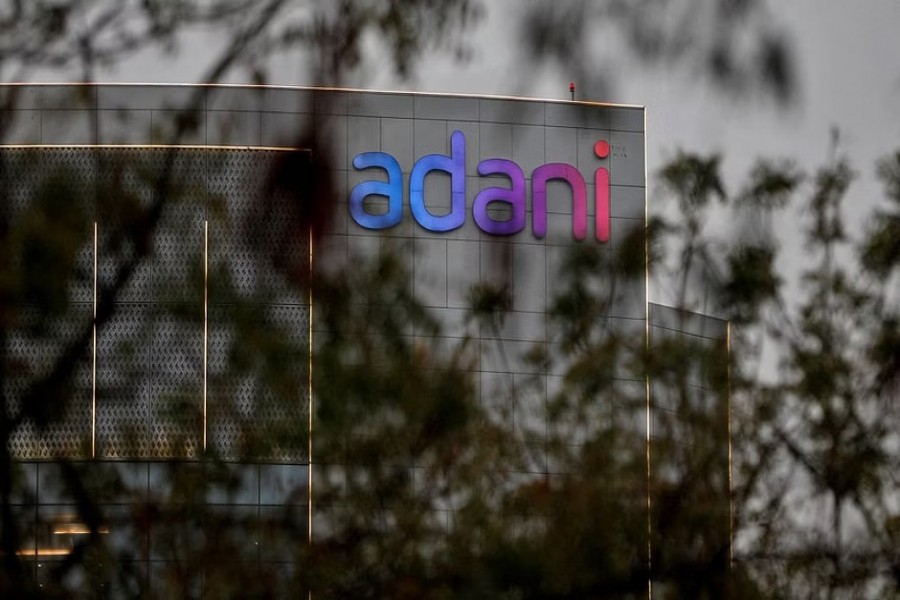 FILE PHOTO: The logo of the Adani Group is seen on the facade of its Corporate House on the outskirts of Ahmedabad, India, January 27, 2023. REUTERS/Amit Dave/File Photo