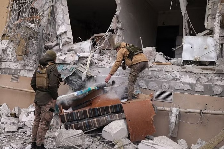 Ukrainian servicemen remove a grad rocket in a damaged house after an attack, amid Russia's invasion of Ukraine, in Kherson, Ukraine January 29, 2023. REUTERS