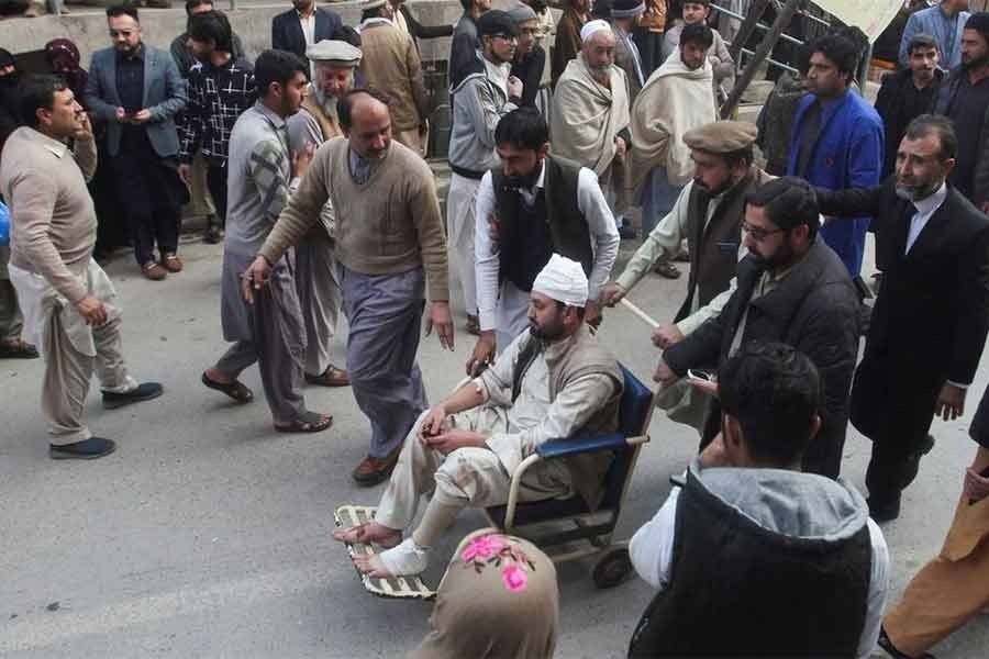 People moving an injured victim, after a suicide blast in a mosque, at hospital premises in Peshawar of Pakistan on Tuesday -Reuters photo