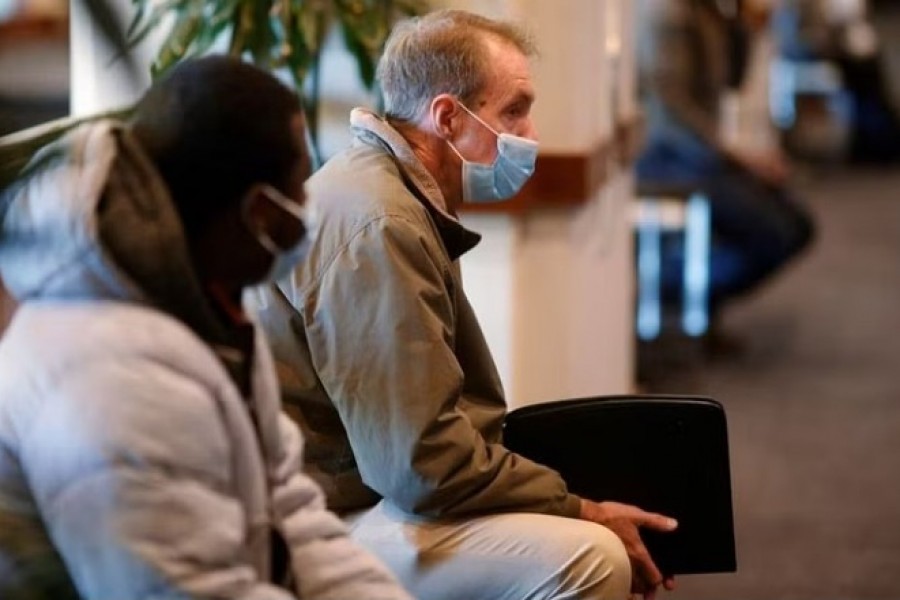 Job seekers wait before a job fair for airport-related employment at Logan International Airport in Boston, Massachusetts, US, Dec 7, 2021. REUTERS