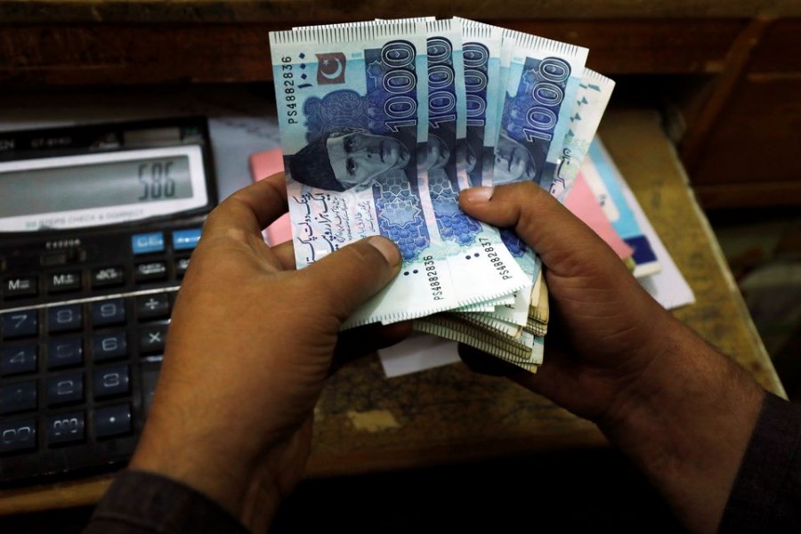 A trader counts Pakistani rupee notes at a currency exchange booth in Peshawar, Pakistan on December 3, 2018 — Reuters/Files